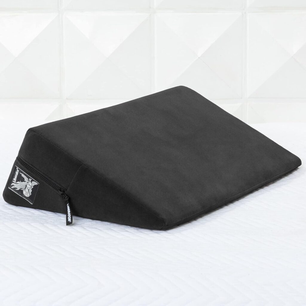 A wedge pillow with a zippered grey cover